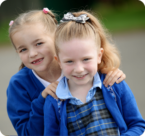 Two girls in school uniform in the playground